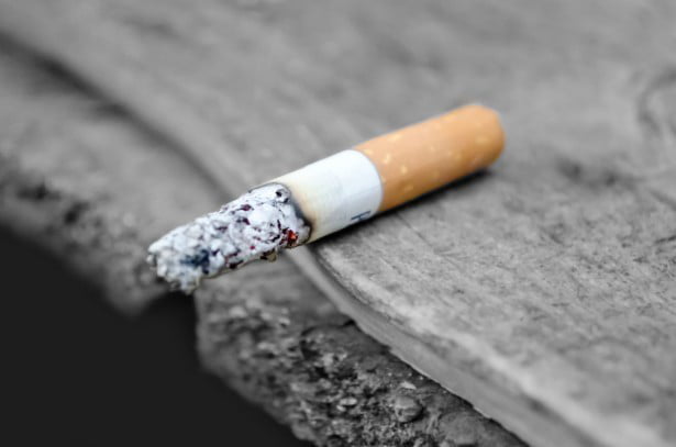 The photo shows a half-burned cigarette.