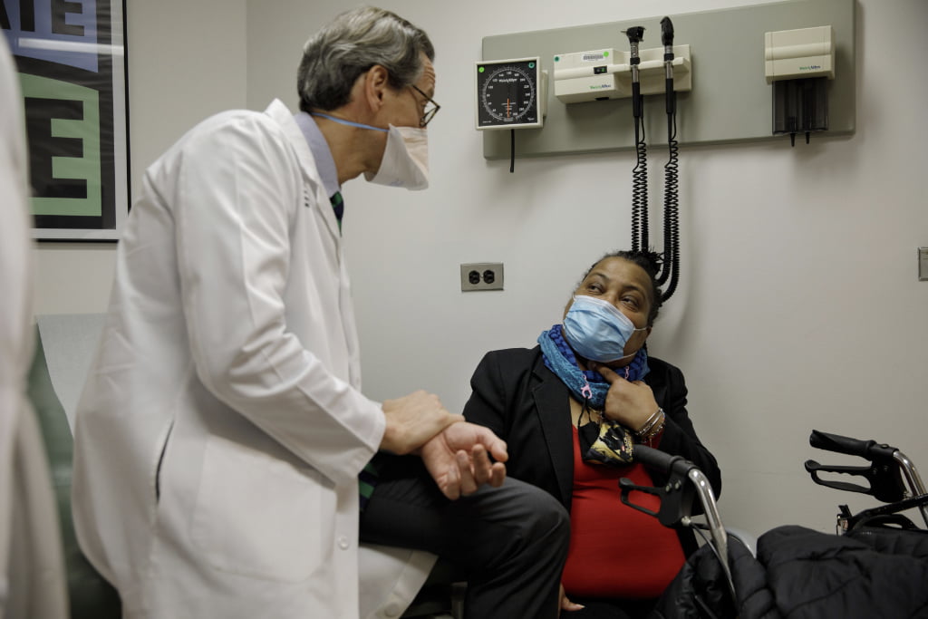 Trachea transplant recipient Sonia Sein talks with the lead surgeon of her procedure, Dr. Eric Genden, left, during a checkup visit at Mt. Sinai hospital in New York.