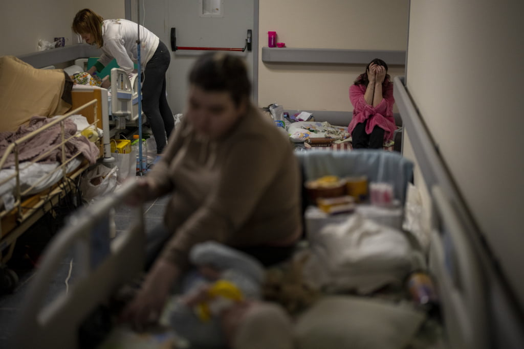 Women care for their sick children at a basement, used as a bomb shelter, at the Okhmadet children's hospital in central Kyiv, Ukraine, Monday, Feb. 28, 2022.