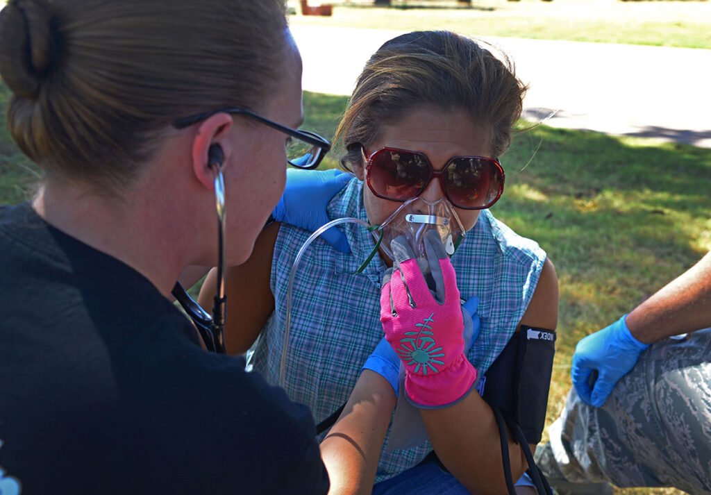A U.S. Air Force emergency medical technician from Eglin Air Force Base, Fla., simulates taking vitals for an asthma attack victim.