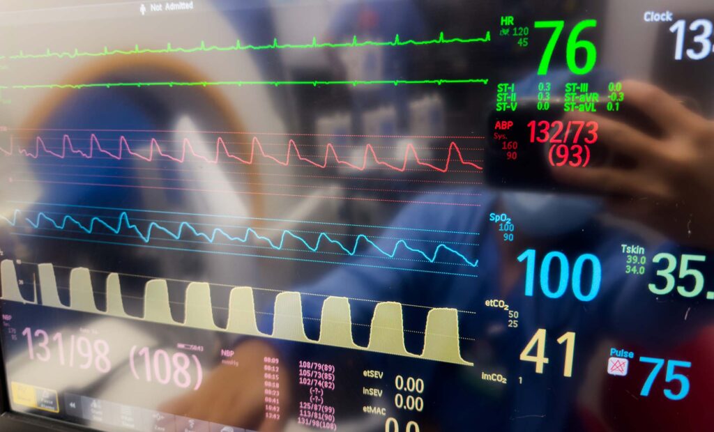 A monitor displaying vital signs - heart rate, pulse ox, temperature, blood pressure. Symbolizing health monitoring, life support, and medical care.