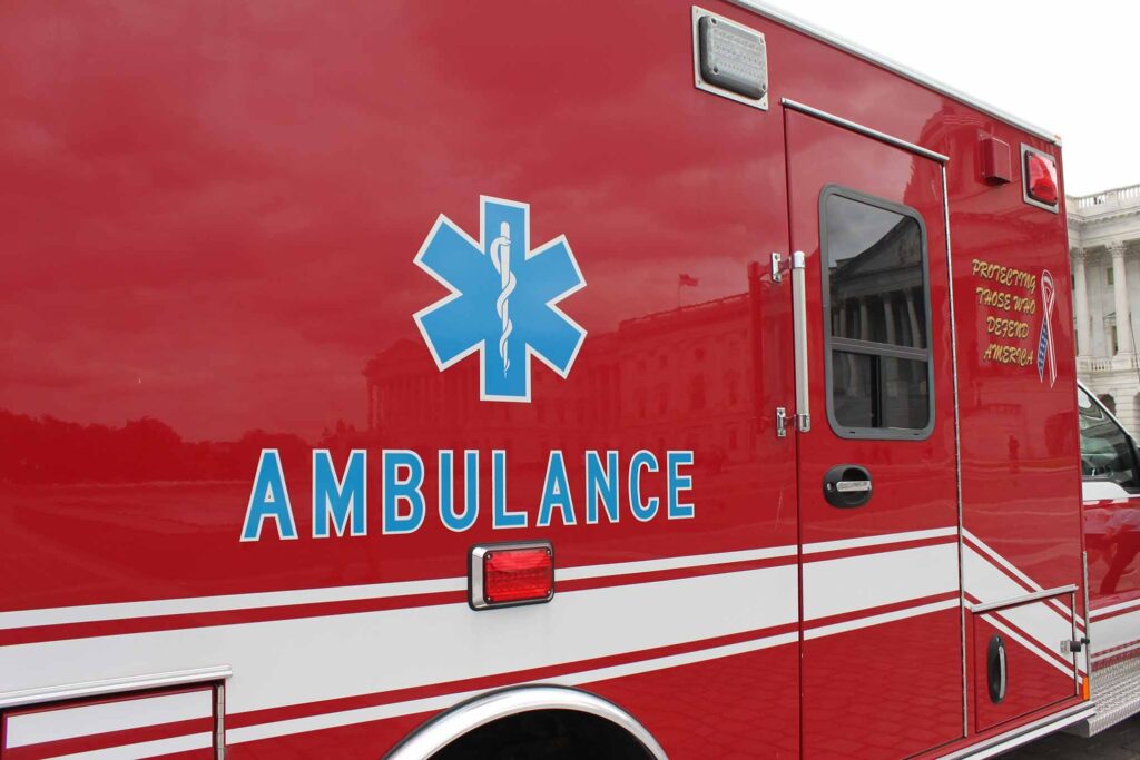 Detail of side of red ambulance car parked in front of US-Capitol at Capitol Hill in Washington DC. Provides emergency medical services. Ford F450